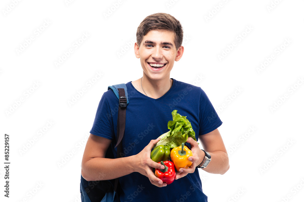 Cheerful male student holding vegetables Cheerful male student holding vegetables