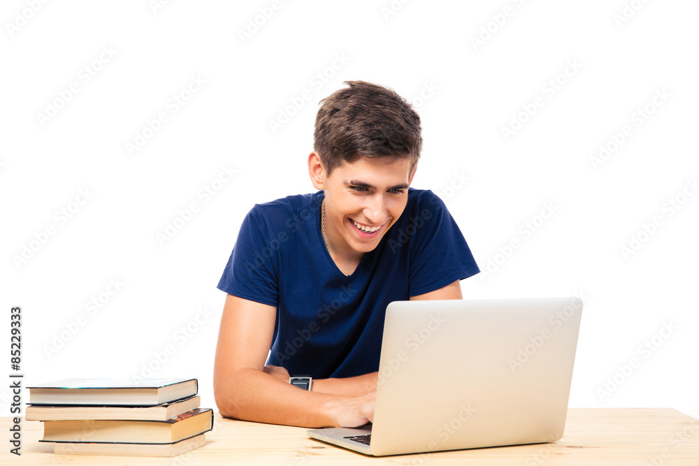 Male student sitting at the table and using laptop Male student sitting at the table and using laptop