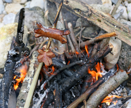 sausages cooked in the bonfire during an outdoor picnic