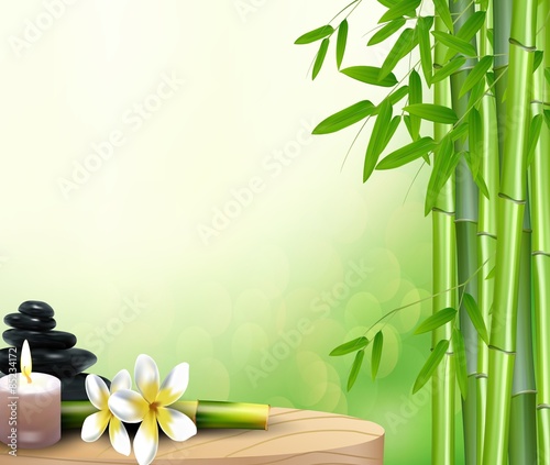 Bamboo, stone, flowers and wax background on the table