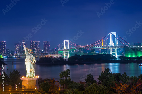 Statue of Liberty and Rainbow bridge at Odaiba Tokyo in twilight