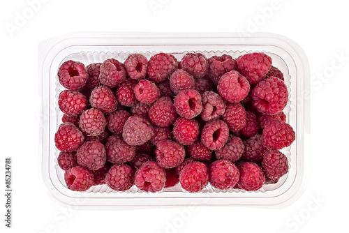 Slika na platnu Box or punnet of fresh ripe organic raspberries isolated on white background