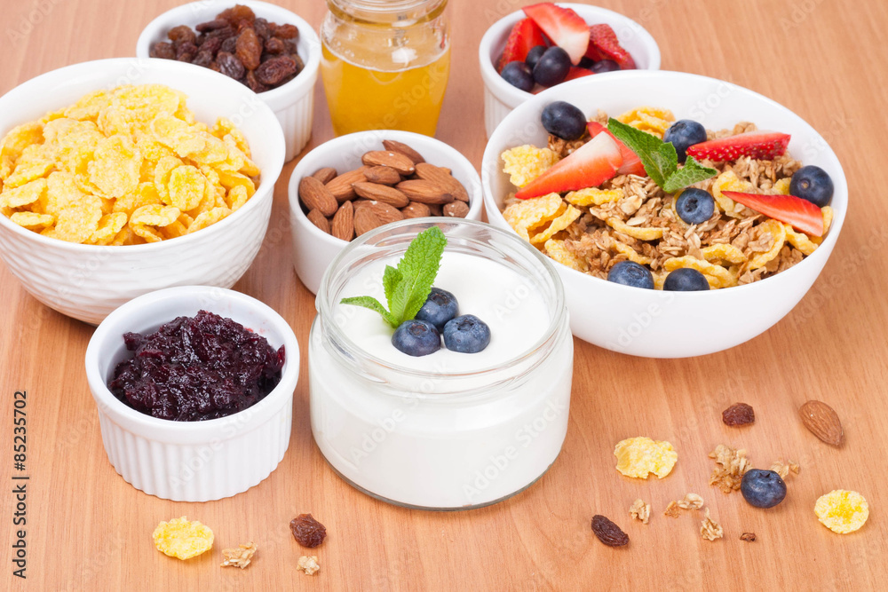 homemade yogurt with fresh berries and breakfast foods on table homemade yogurt with fresh berries and breakfast foods on table