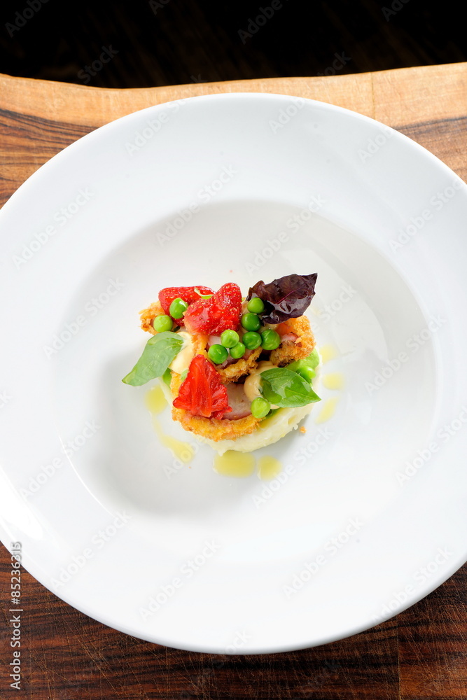 Fine dining, Fried Octopus on potato purree, green peas and fresh strawberries Fine dining, Fried Octopus on potato purree, green peas and fresh strawberries