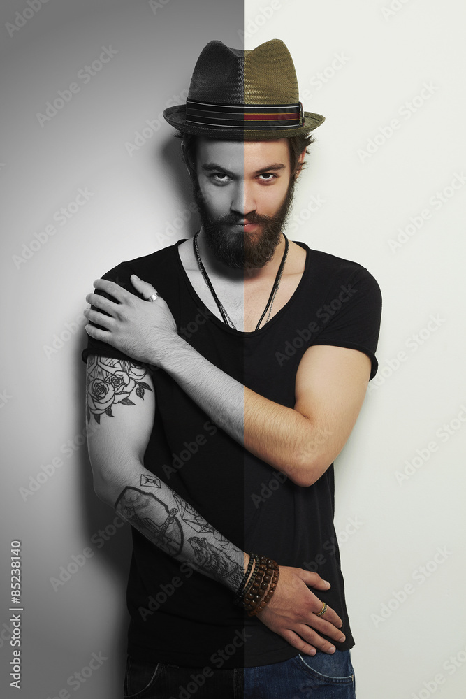 handsome bearded man in hat.Brutal boy with tattoo handsome bearded man in hat.Brutal boy with tattoo