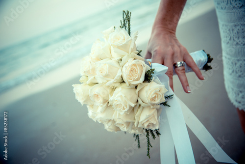 Bride hands on yellow flowers