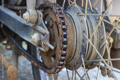 Dirty chain on wheel of old motorcycle
