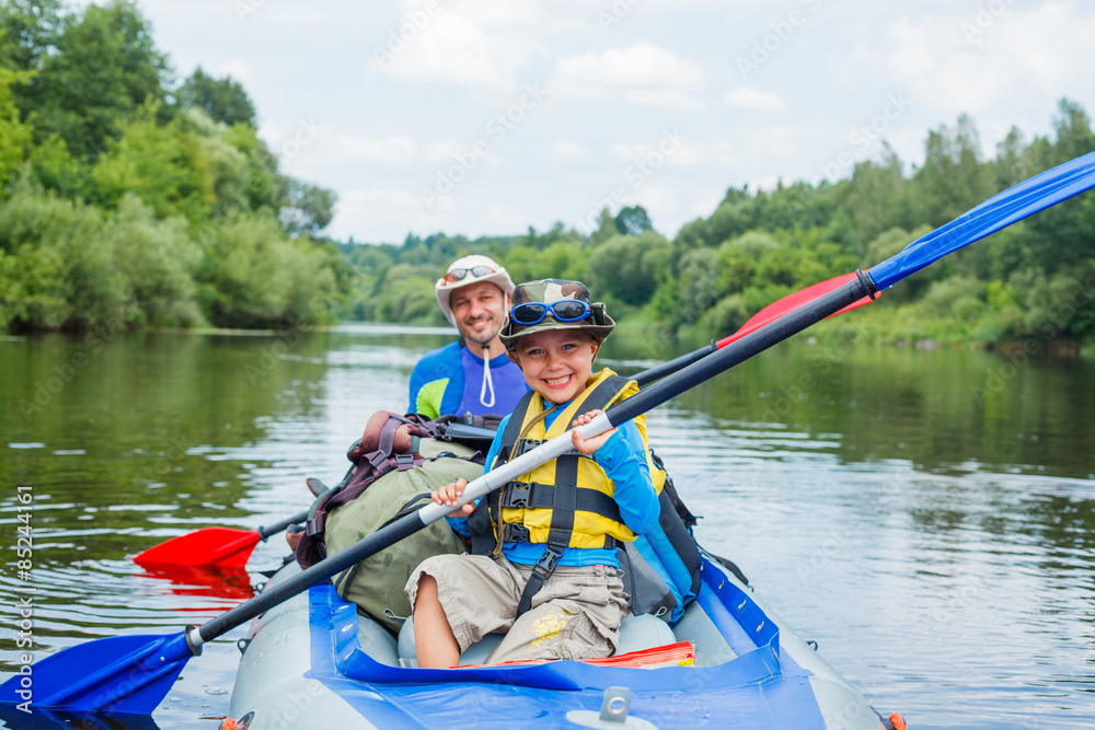 Boy with his father kayaking