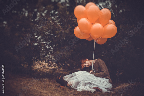 unusual woman with balloons as concept outdoors