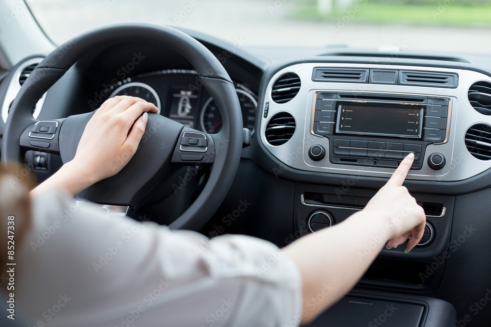 asian femle driver touching dashboard in car asian femle driver touching dashboard in car