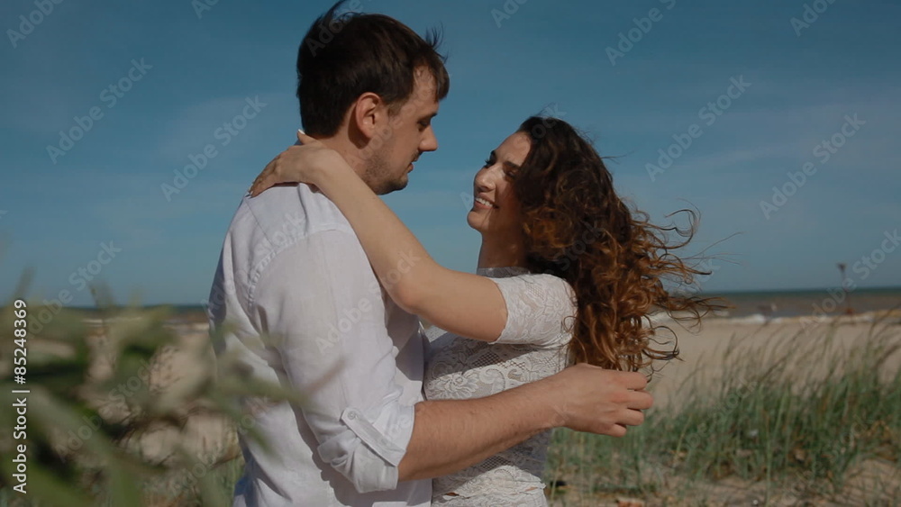 Two young people of caucasian etnicity on the beach look at each other,show their feelings. Love and care concept. Two young people of caucasian etnicity on the beach look at each other,show their feelings. Love and care concept.
