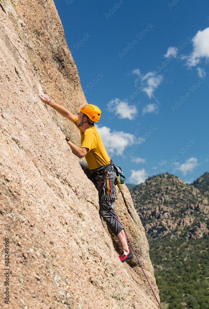 Senior man on steep rock climb in Colorado
