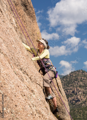 Senior lady on steep rock climb in Colorado