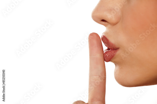 finger on her lips. silence gesture photo