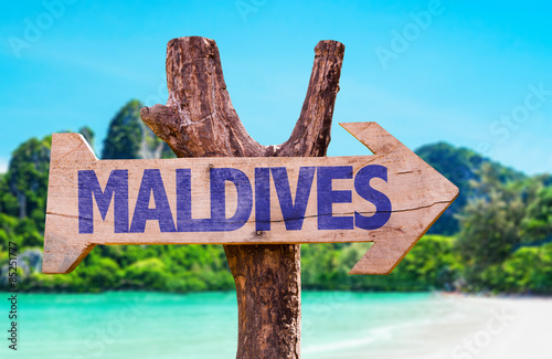 Maldives wooden sign with beach background