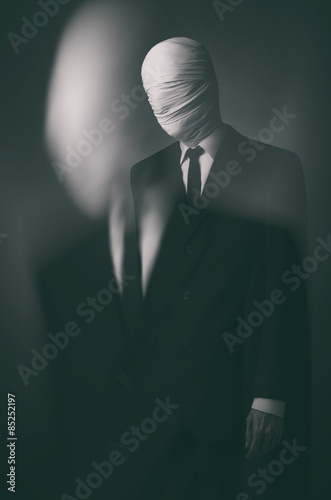 Internet meme and terrible character Halloween theme: very tall burly man with long arms in a suit with bandaged face fabric, an unknown killer in the suit, The Slender Man, Secret legend of the city photo