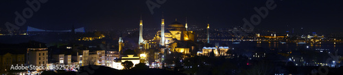 Wide angle panorama of Istanbul old city district nightlight illumination Large panorama including most famous attractions Sophia Blue Mosque water Bosporus and Asian side town on background