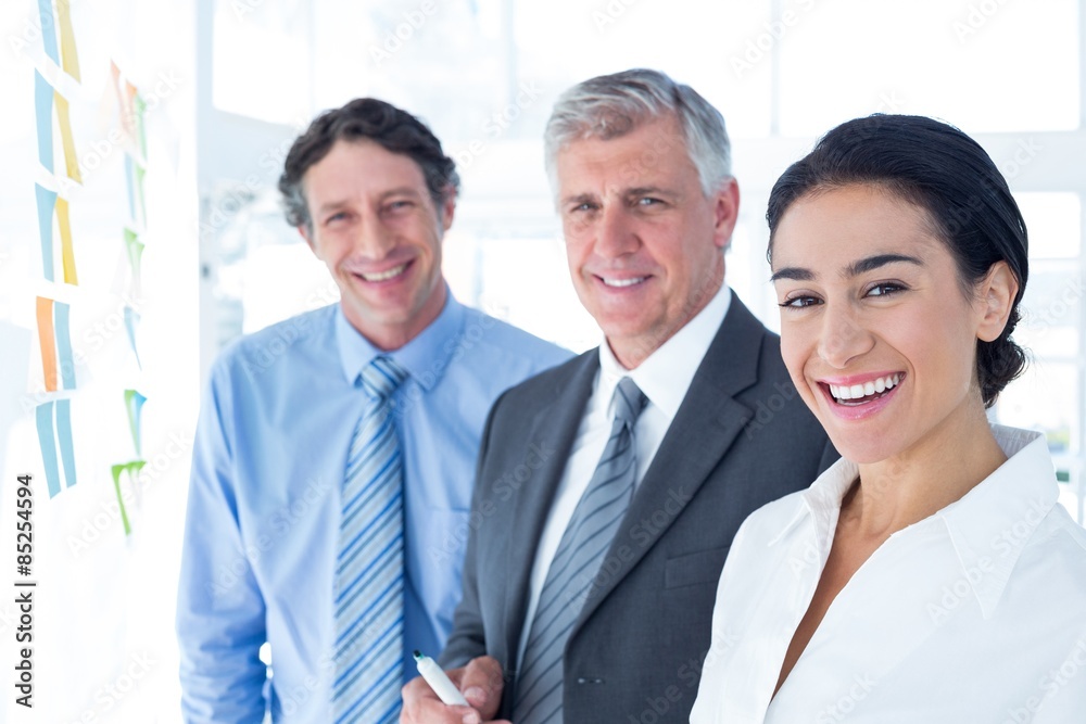 Smiling business people brainstorming together Smiling business people brainstorming together