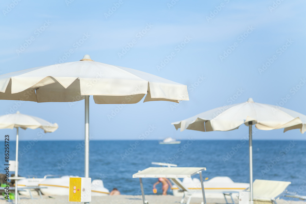 Sun umbrellas on fashionable sea beach