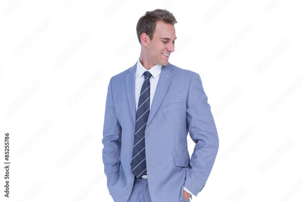 Happy handsome businessman smiling with hands on pockets Happy handsome businessman smiling with hands on pockets