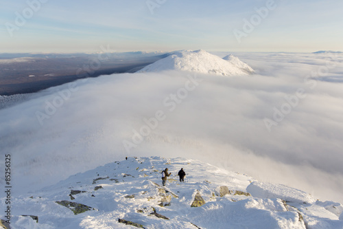 tourists descend from the mountains, a cloud passes over the mountain