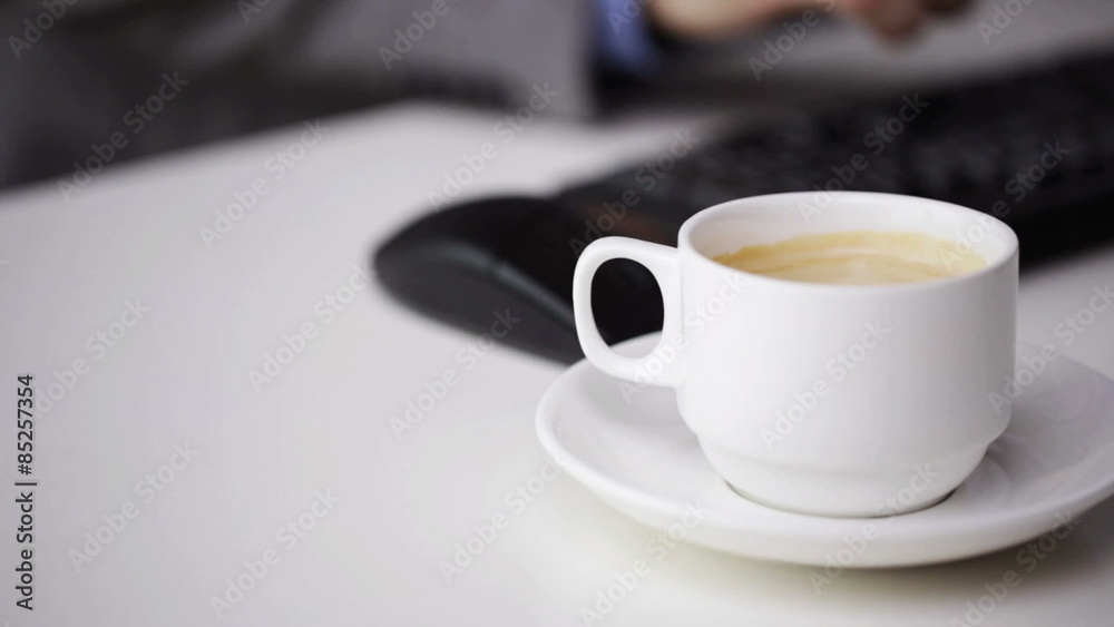 close up of businessman typing and drinking coffee close up of businessman typing and drinking coffee