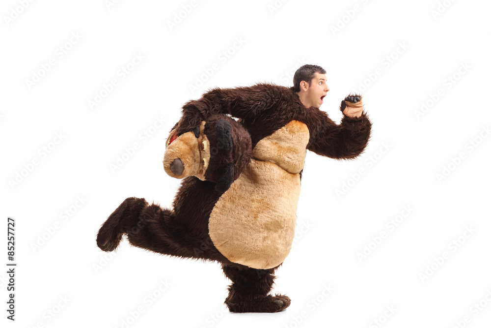 Horrified man in a bear costume running Stock Photo | Adobe Stock