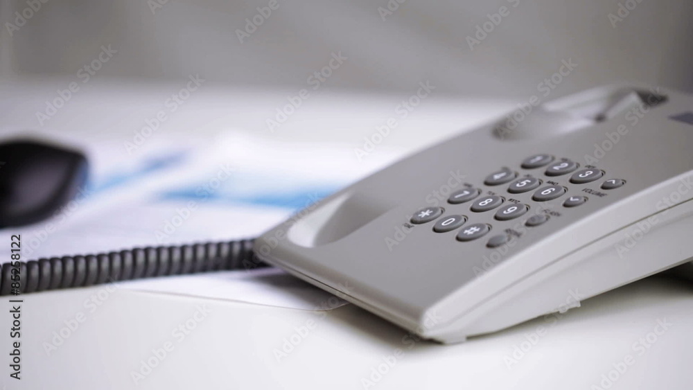 close up of businessman hand dialing phone number close up of businessman hand dialing phone number