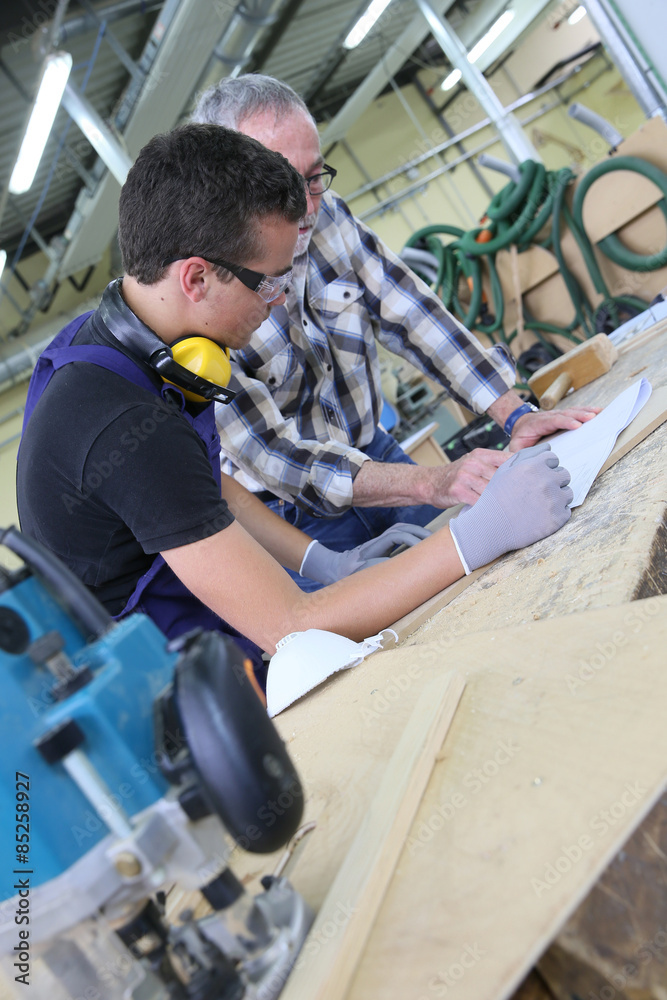 Carpenter with apprentice in training period Carpenter with apprentice in training period