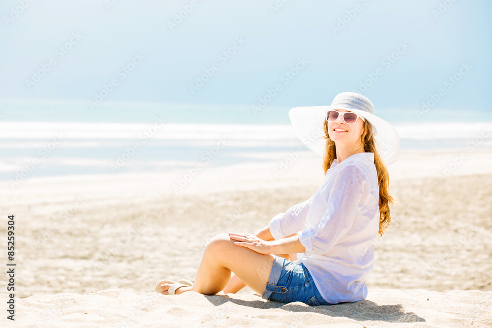 Beautifil young woman sitting on the beach at sunny day enjoing Beautifil young woman sitting on the beach at sunny day enjoing
