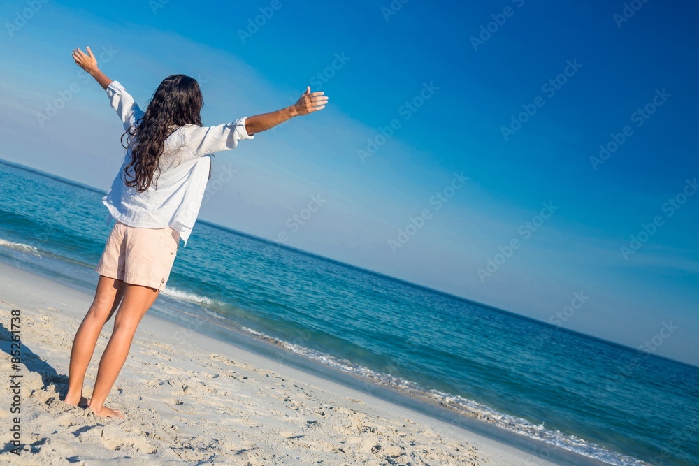 Happy woman with arms outstretched at the beach Happy woman with arms outstretched at the beach