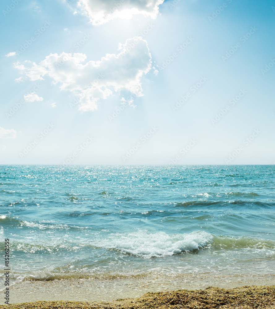 Naklejka premium wave on sea and blue sky with clouds and sun