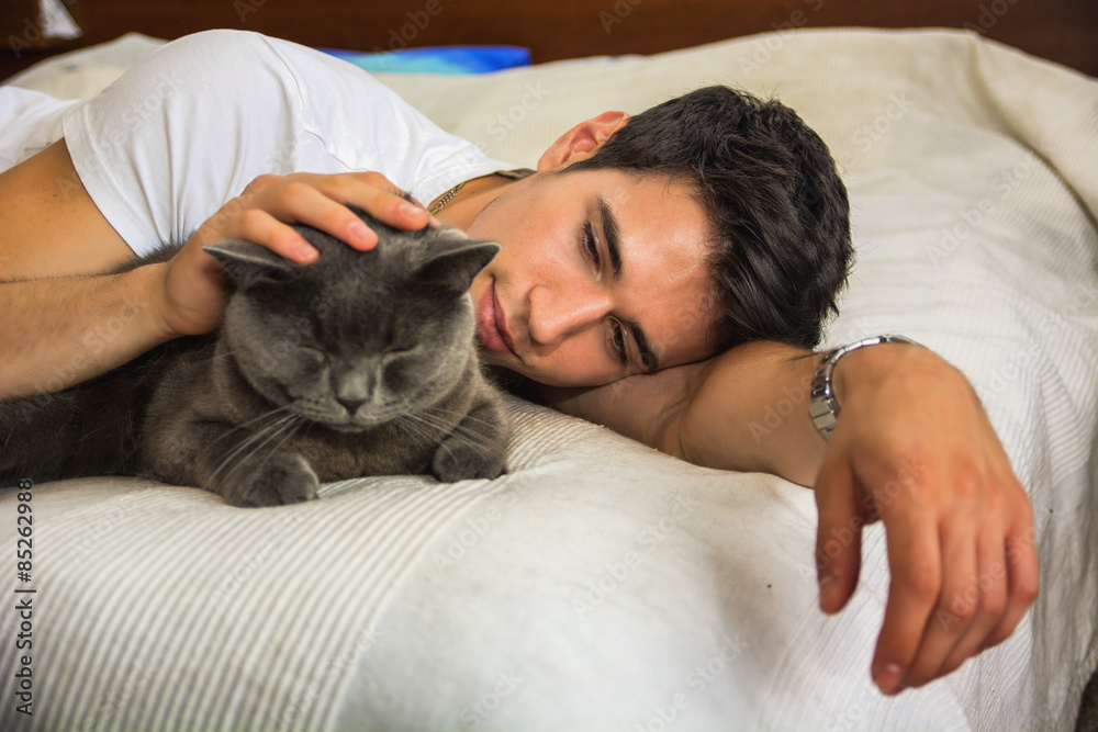 Handsome Young Man Cuddling his Gray Cat Pet Handsome Young Man Cuddling his Gray Cat Pet