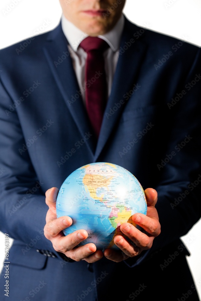 Hand of businessman holding terrestrial globe Hand of businessman holding terrestrial globe