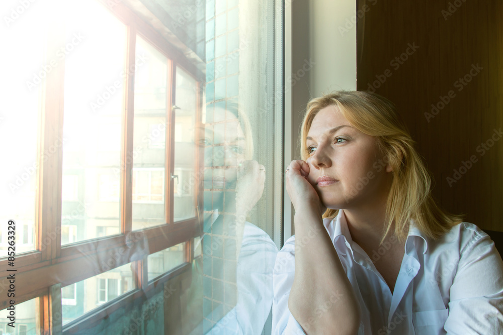 The woman lost in thought looking out the window.