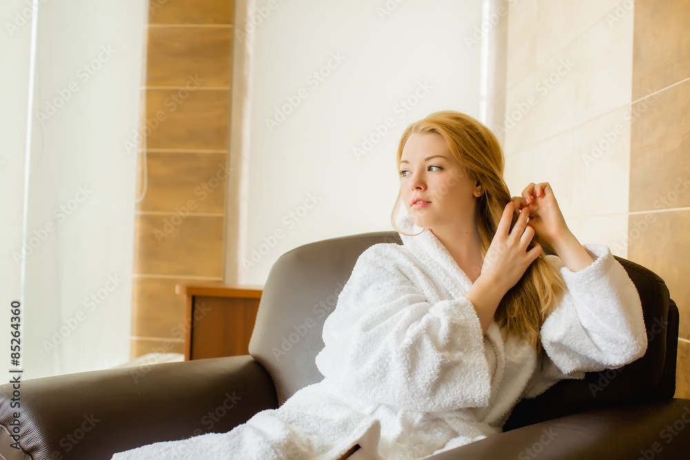 Beautiful young blonde girl in a white robe caresses Beautiful young blonde girl in a white robe caresses