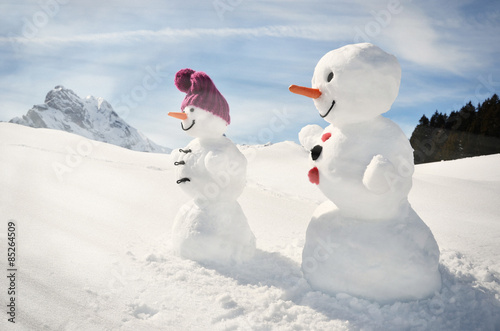 Funny snowmen against Swiss Alps photo