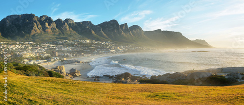 Camps Bay Beach in Cape Town at sunset, South Africa, with the Twelve Apostles in the background.