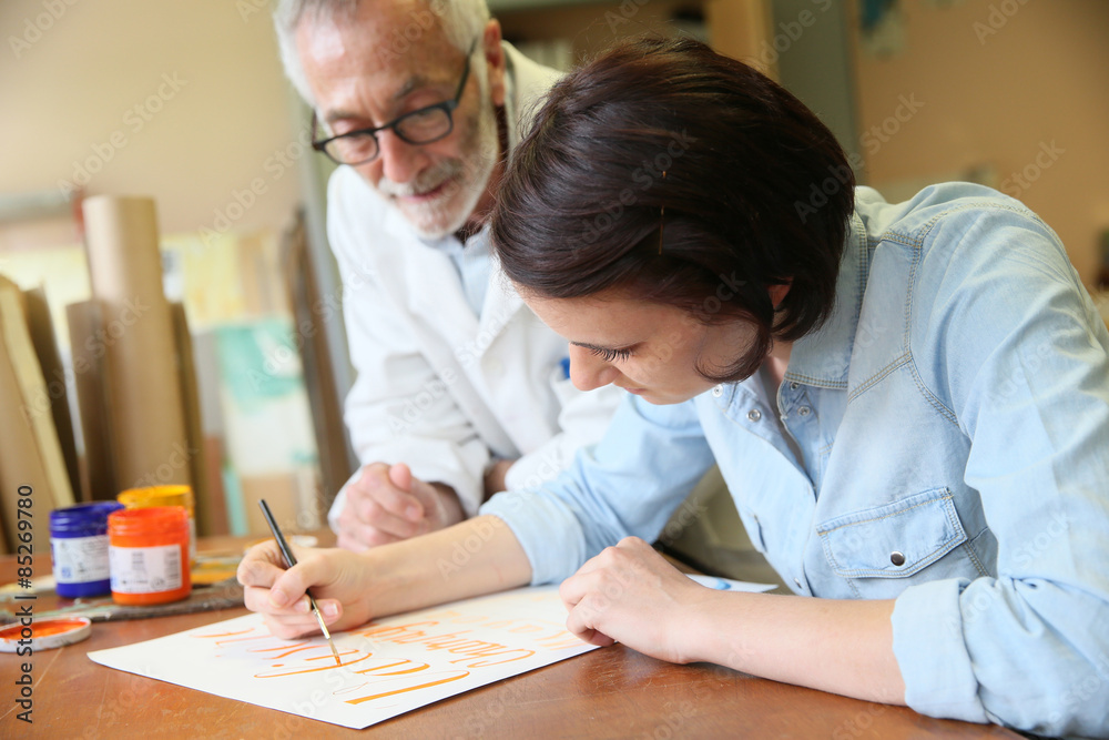 Young woman at school studying decorative painting Young woman at school studying decorative painting