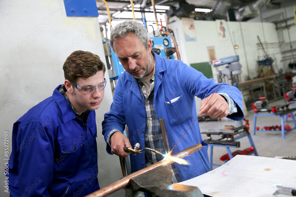 Teacher with student in metallurgy workshop Teacher with student in metallurgy workshop