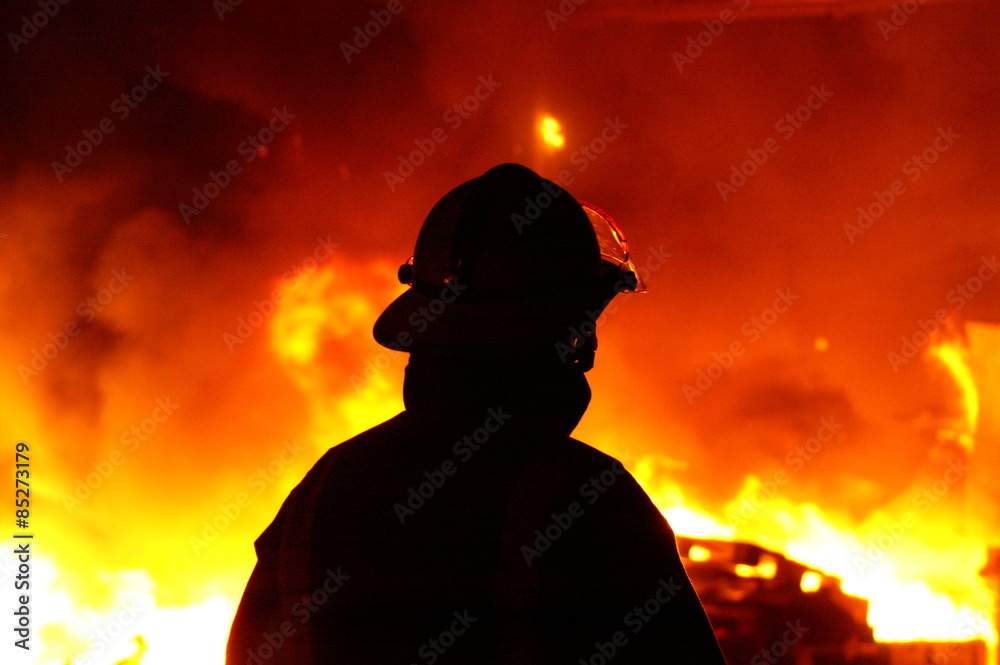 Fototapeta premium fire fighters at large factory fire