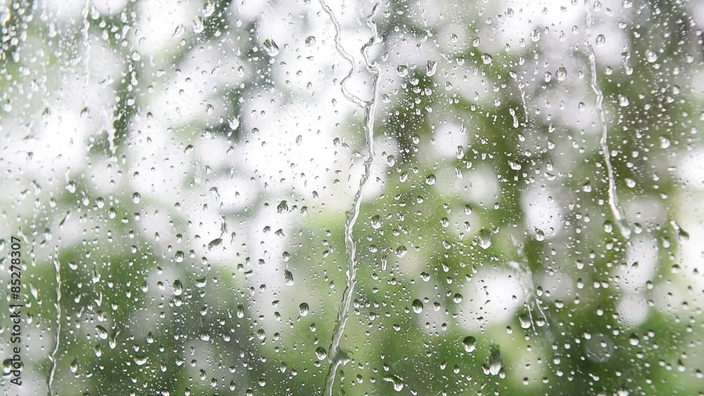 Close up image of rain drops falling on a window 