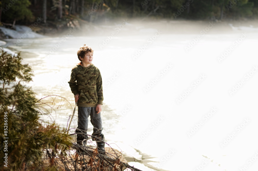 boy by a misty lake