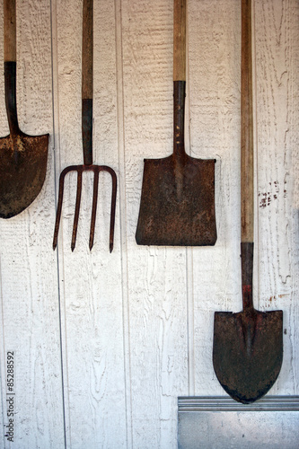 Gardening tools hanging on the wall