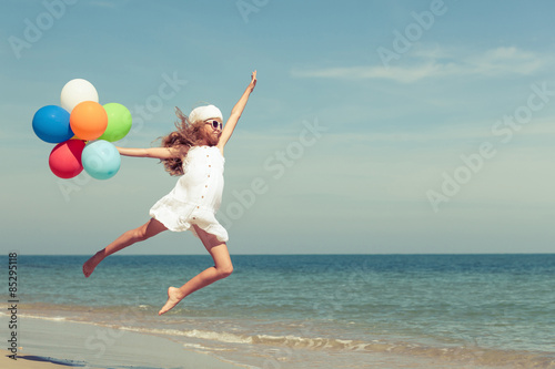 Teen girl jumping on the beach