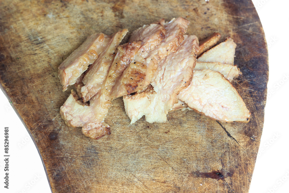 Sliced grilled pork chop on a wooden board Sliced grilled pork chop on a wooden board