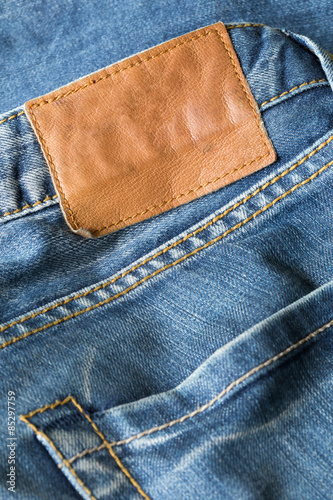 brown leather tag on blue jeans