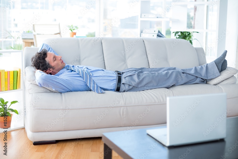 Businessman lying on couch Businessman lying on couch