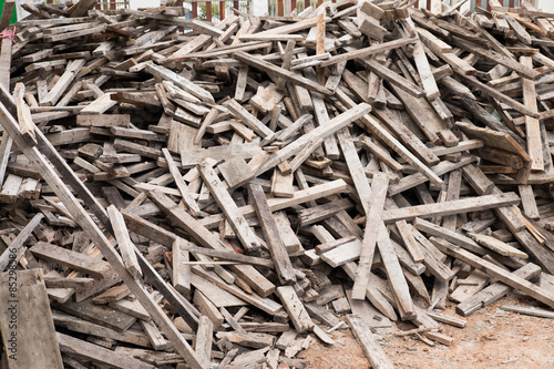 A scrap wood pile with protruding rusty nails