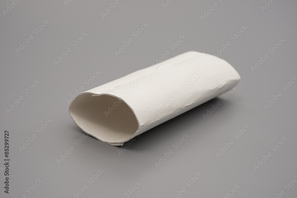 smashed toilet roll with the last bit of tissue on grey smashed toilet roll with the last bit of tissue on grey